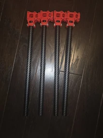 Separate quadcopter arm tubes with printed red motor-mount components