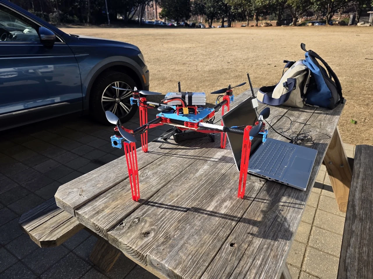 Assembled quadcopter with printed components and tube arms on a table outdoors